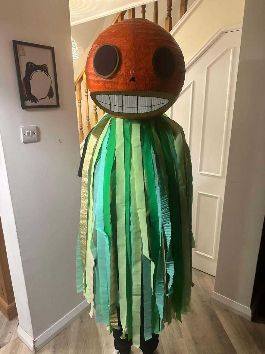 Person wearing a creative giant orange head creative Halloween costume