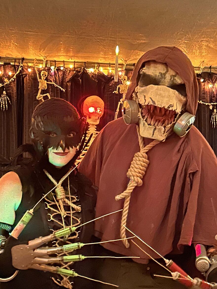 Couple wearing scary villain themed Halloween costumes with glowing details