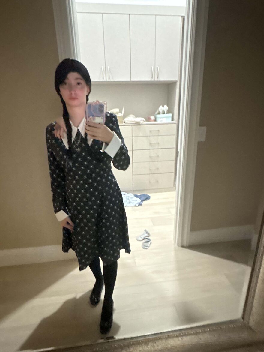 Person taking a selfie dressed up in a Wednesday Addams Halloween costume.