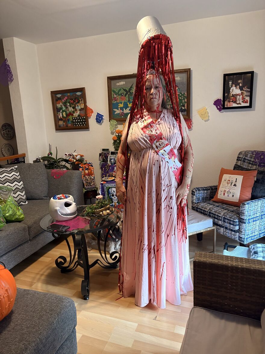 Woman dressed as Carrie covered in fake blood demonstrating creative Halloween costumes