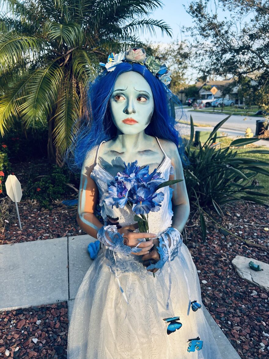 Woman in corpse bride Halloween costume with blue body paint and blue hair