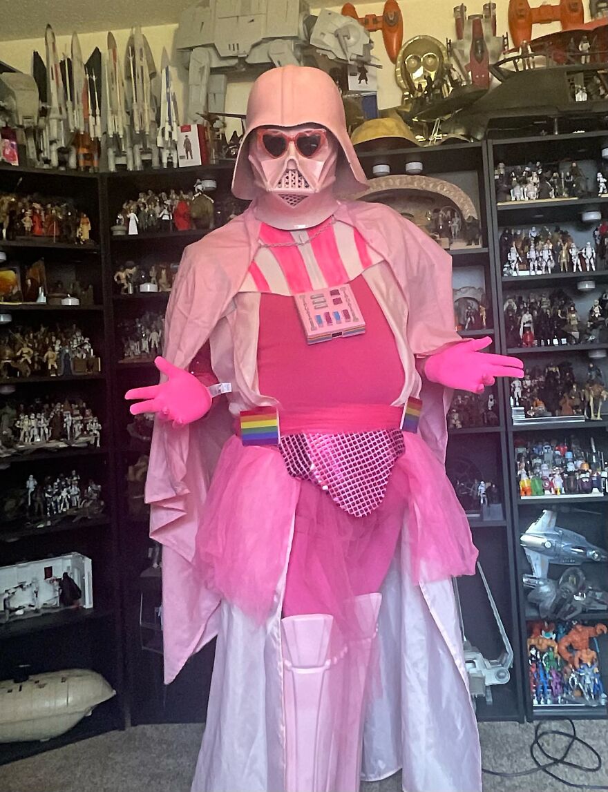 Creative pink Darth Vader Halloween costume displayed in a room filled with sci-fi memorabilia.