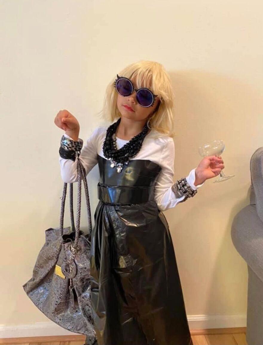 Young girl dressed up in a stylish fashion outfit as part of unique Halloween costumes.