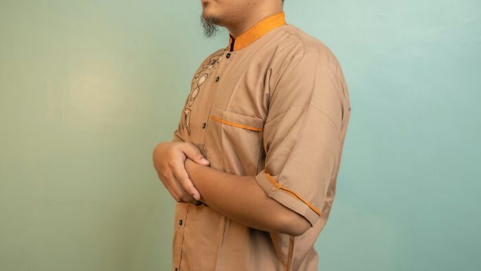A man standing in a calm pose, illustrating self-control and personal emergency tips.
