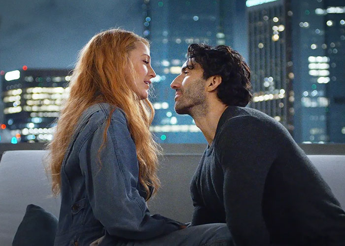 Blake Lively in a scene from a movie facing a co-star against a city skyline. Blake Lively in a scene from a movie facing a co-star against a city skyline.