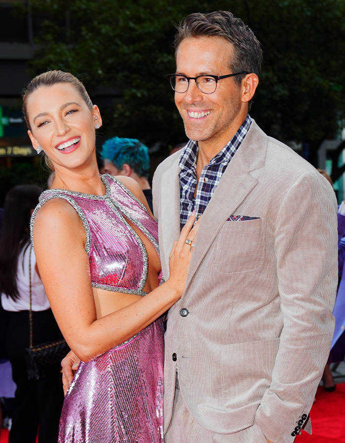 Blake Lively in a pink dress and Ryan Reynolds in a suit on a red carpet as celebrity texts news spreads. Blake Lively in a pink dress and Ryan Reynolds in a suit on a red carpet as celebrity texts news spreads.