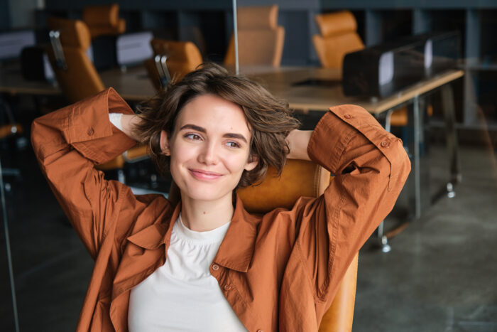 A relaxed woman sitting at an office desk symbolizing relief from GF checks the flight tracker story.