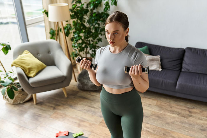 Woman working out at home to manage weight related to diabetes diagnosis Woman working out at home to manage weight related to diabetes diagnosis