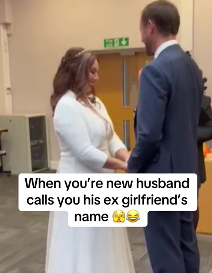 Bride in white dress holding hands with groom while reciting wedding vows that caused outrage.