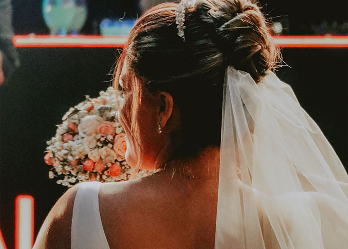 A bridezilla with her hair in an elegant bun holding her bouquet.
