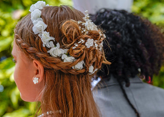 A flower girl with styled hair and a floral crown before bridezilla ruins hotel rooms