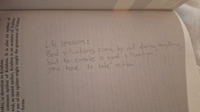 Found paper inside a book with a handwritten life lesson about taking action.
