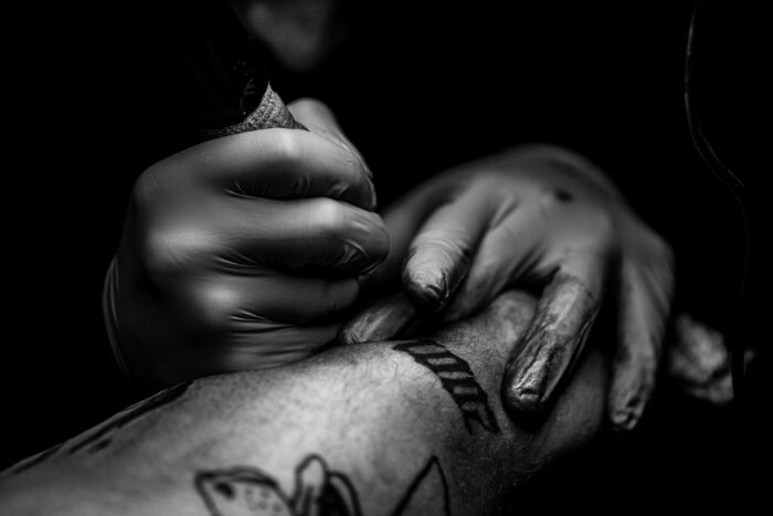 Close-up of a tattoo artist at work, relevant to the story of why a woman refuses to marry her fiancé. Close-up of a tattoo artist at work, relevant to the story of why a woman refuses to marry her fiancé.