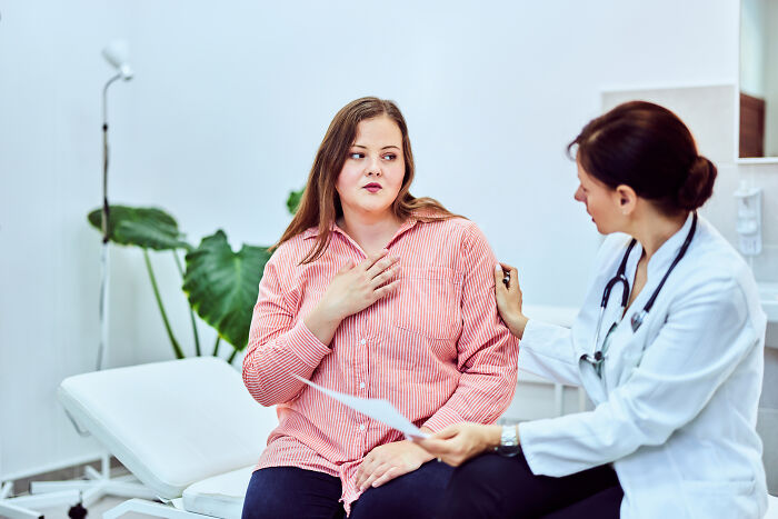 Female patient consulting doctor about health concerns