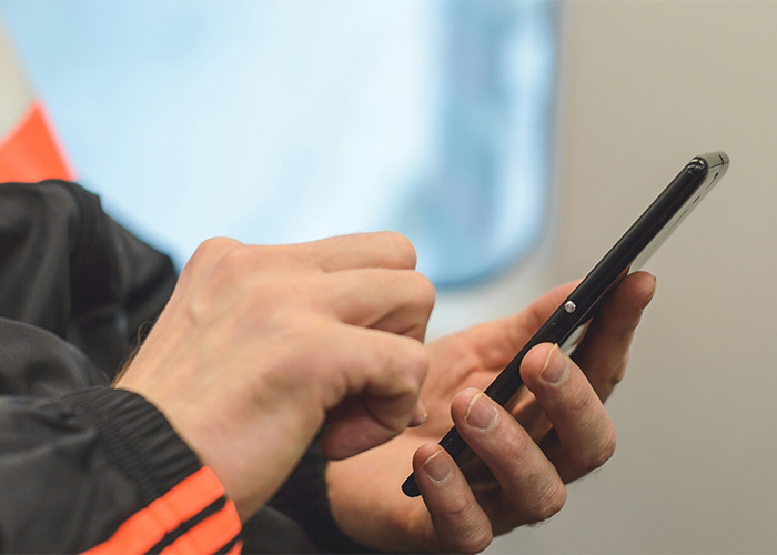 Close-up of hands typing a chilling text on passenger's phone inside an airplane. Close-up of hands typing a chilling text on passenger's phone inside an airplane.