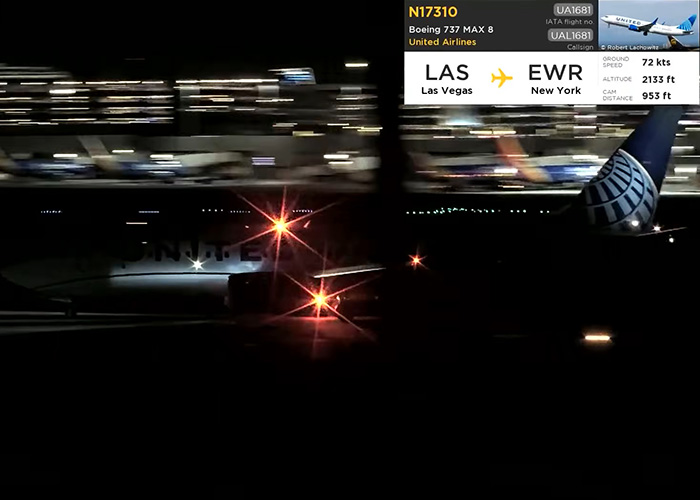 A United Flight airplane on the tarmac at night showing flight tracking details. A United Flight airplane on the tarmac at night showing flight tracking details.