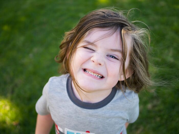 Young child pulling a silly face during arguments related to family feuds