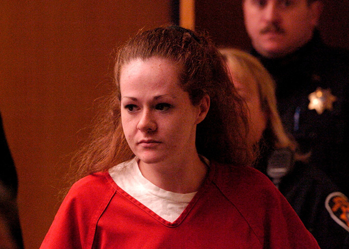 Courtroom photo of Christa Pike in red jail attire during a trial proceeding.