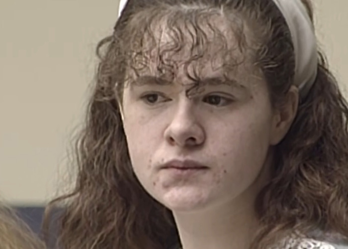 Close-up of young Christa Pike with curly brown hair and a white headband.