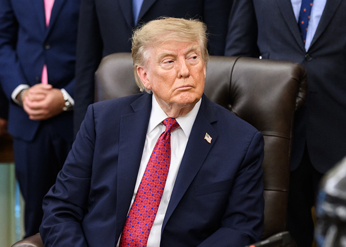 Donald Trump sitting in a brown leather chair, which might relate to the Christa Pike case