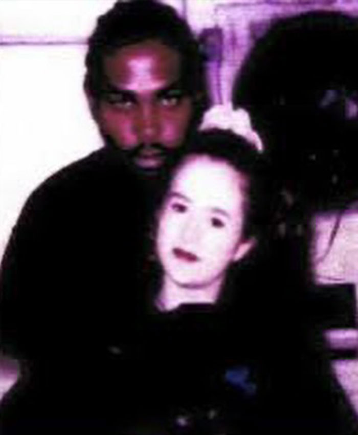 A dark photograph showing Christa Pike alongside a young man