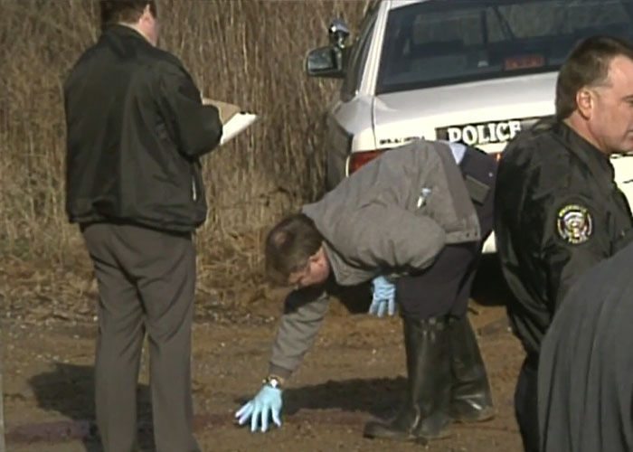 Police investigators examine the crime scene connected to Christa Pike's conviction