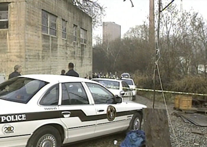 A police car parked near an investigation site relevant to the case of Christa Pike.