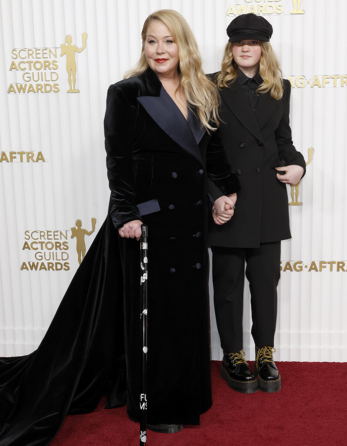 Christina Applegate poses with her daughter holding a cane at an awards show. Christina Applegate poses with her daughter holding a cane at an awards show.