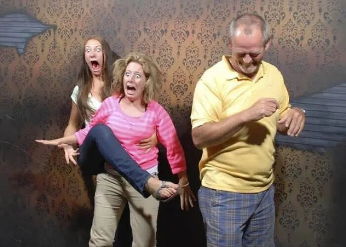Funny haunted house photo of terrified people reacting with shock