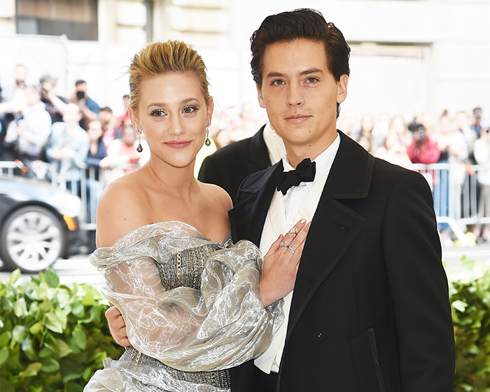Cole Sprouse and Lili Reinhart posing together at a formal event