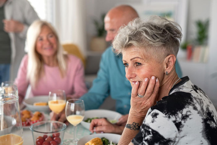 Toxic mom looking controlling and tense during a family meal Toxic mom looking controlling and tense during a family meal