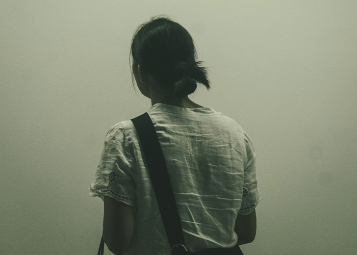 Woman seen from behind in contemplation linked to Cornell 7 case Woman seen from behind in contemplation linked to Cornell 7 case