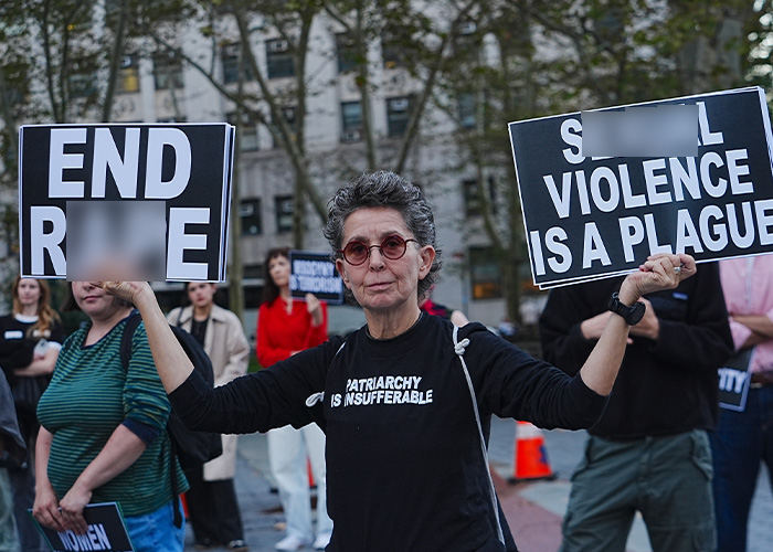 Protester holding signs to end s****l violence at Cornell demonstration Protester holding signs to end s****l violence at Cornell demonstration