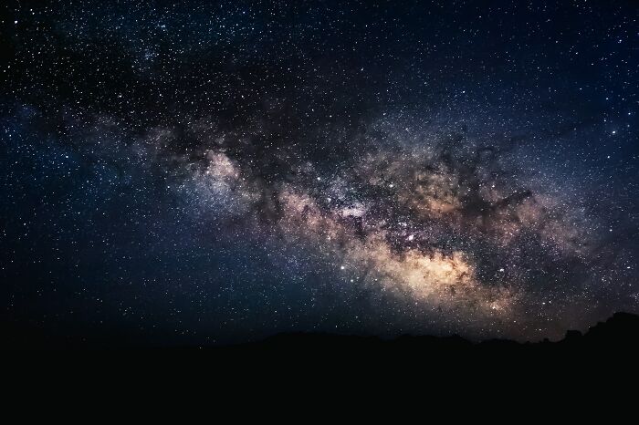 A wide shot of the starry night sky showing the Milky Way, hinting at non-human intelligence in the universe A wide shot of the starry night sky showing the Milky Way, hinting at non-human intelligence in the universe