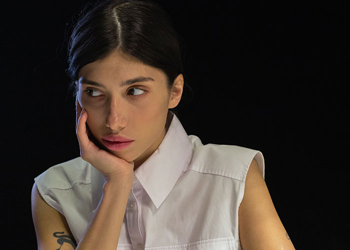 A thoughtful young woman rests her chin on her hand, looking concerned as she considers whether to trick BF. A thoughtful young woman rests her chin on her hand, looking concerned as she considers whether to trick BF.