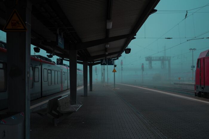 Foggy and deserted train station platform at dusk, giving off chilling spooky things feelings.