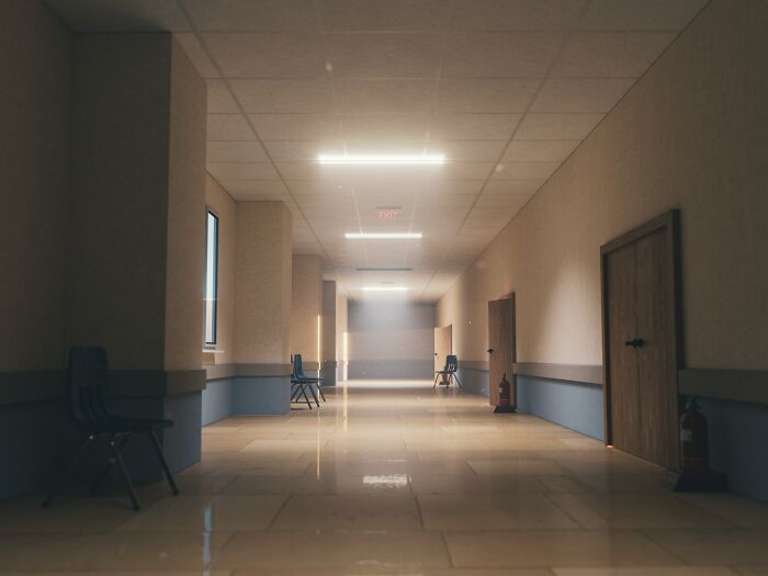 Eerie empty hallway with dim overhead lights, adding to the list of spooky things experienced by people.