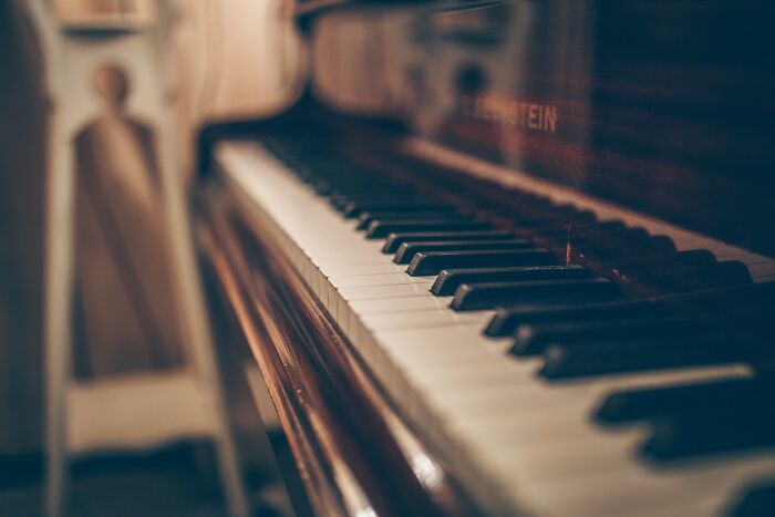 Close up of piano keys in low light, evoking spooky things and unsettling experiences.