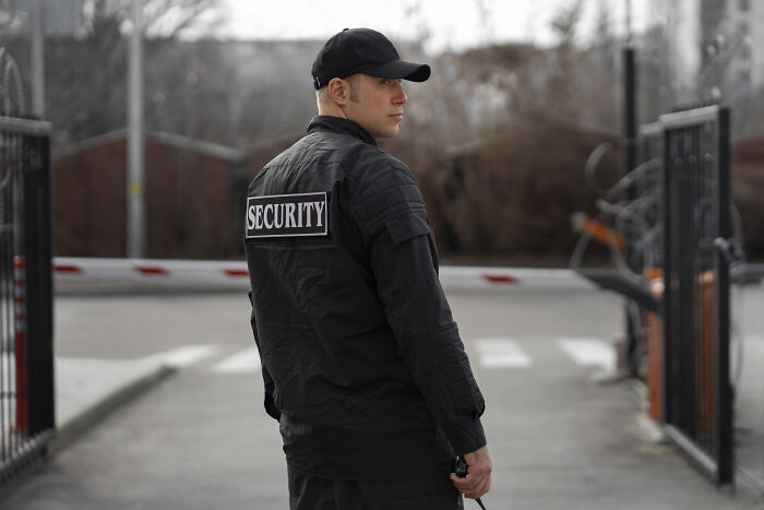 A security guard looking over his shoulder, showing spooky things witnessed on duty.
