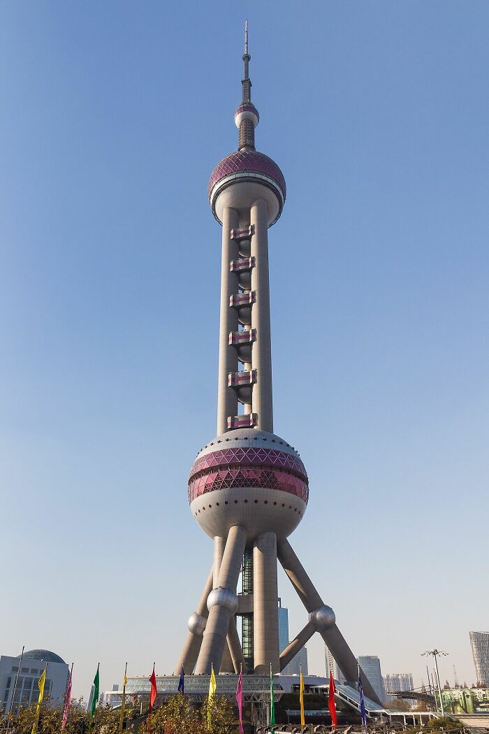 Futuristic Oriental Pearl Tower with spheres and tall spire in clear daylight