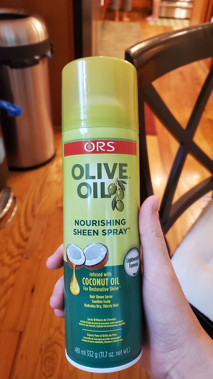 A hand holding olive oil spray with coconut oil text, showing advertising fails