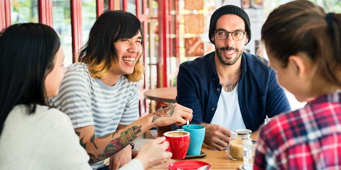 A group of friends talking over coffee, showing behaviors they refuse to tolerate in other women