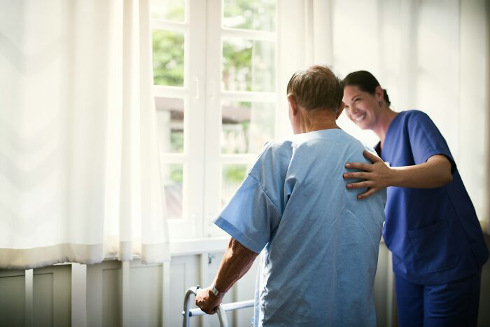 Nurse assisting an elderly patient in a care facility, showing trusted healthcare industry insiders.