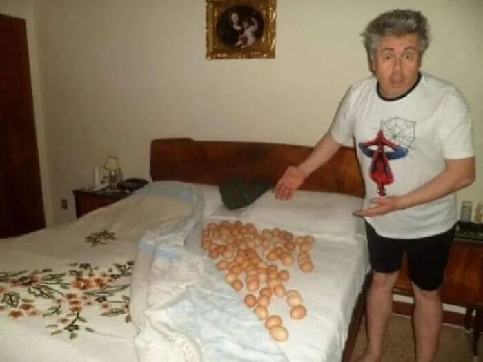 Man pointing at bed covered with scattered eggs surreal cursed photo
