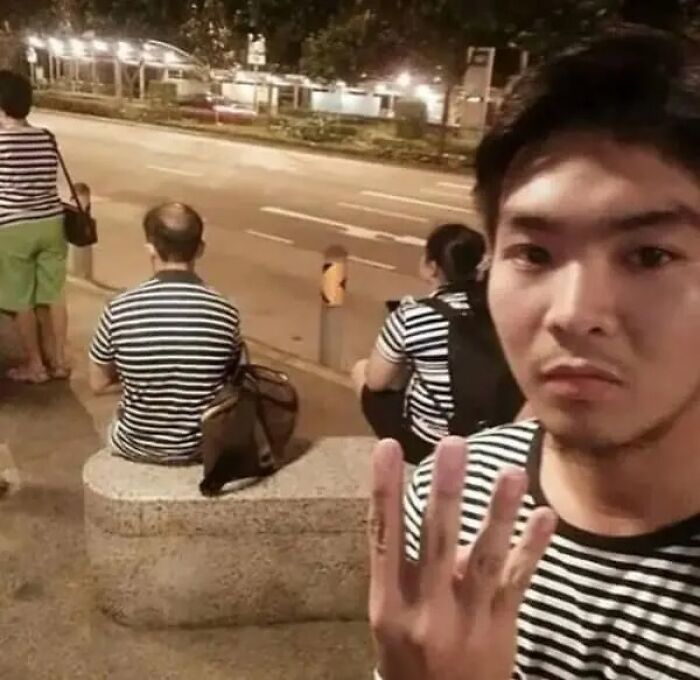Cursed image showing people in striped shirts blending into background in matching pattern.