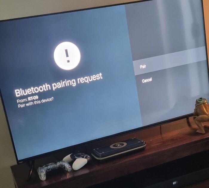 Absurd moment displaying an unexpected Bluetooth pairing request screen on a smart TV