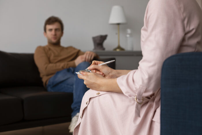 A man sitting in a therapy session regarding his grounds for divorce.