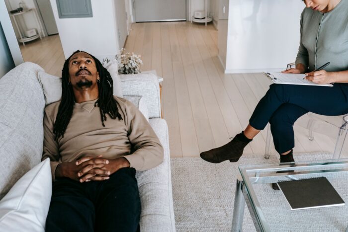 A man talking to a therapist after finding grounds for divorce in his marriage.