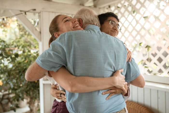 Family members embracing outdoors, symbolizing reconciliation after a husband decides on divorce.