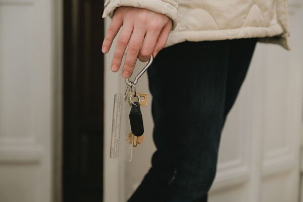 Person holding keys symbolizing moving out during divorce process